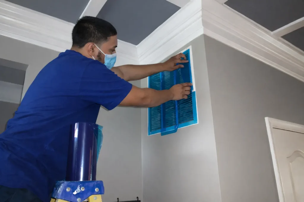 HVAC technician installing new air filter during system maintenance